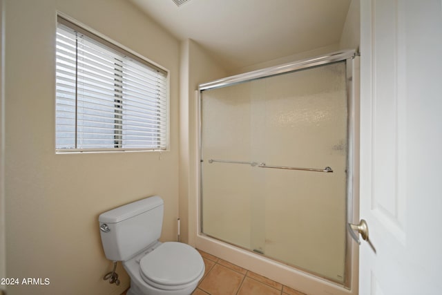 bathroom with tile patterned flooring, an enclosed shower, and toilet