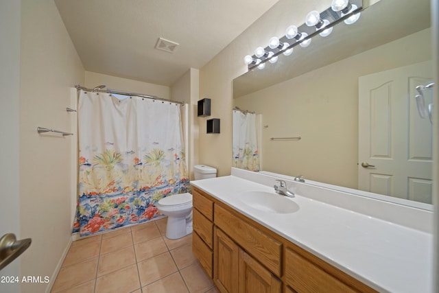 bathroom featuring vanity, a shower with shower curtain, tile patterned floors, and toilet