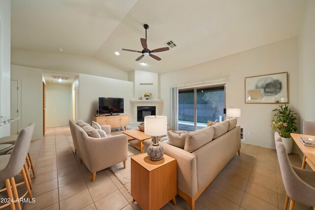 tiled living room featuring lofted ceiling and ceiling fan