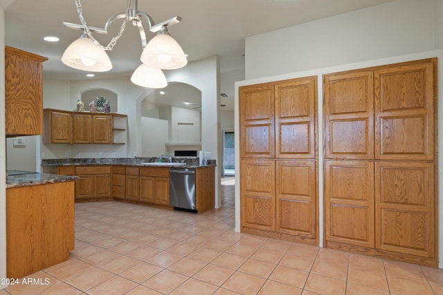 kitchen featuring hanging light fixtures, light tile patterned flooring, sink, and stainless steel dishwasher