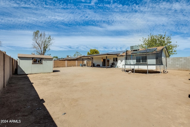 view of yard featuring a shed and a trampoline