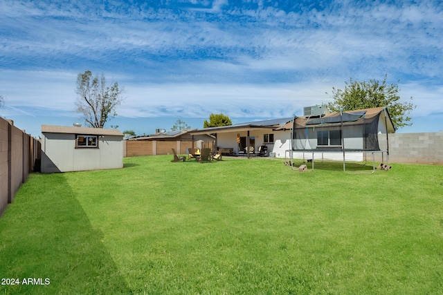 view of yard with a shed and a trampoline