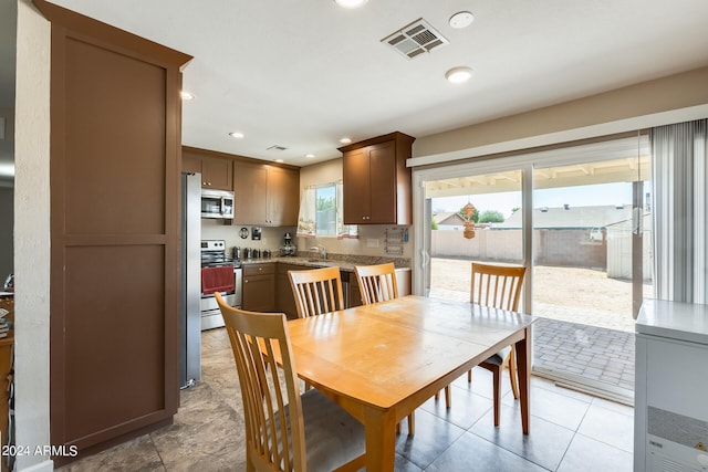 dining space featuring light tile patterned flooring