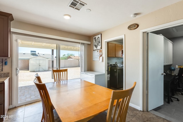 dining space with tile patterned flooring and washer and dryer