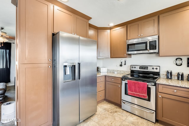 kitchen featuring light stone counters and appliances with stainless steel finishes