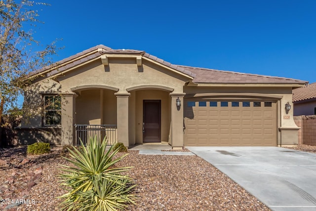 43958 W Stonecreek Rd, Maricopa, AZ 85139 - mediterranean / spanish-style home featuring a garage, stucco siding, driveway, and a tile roof