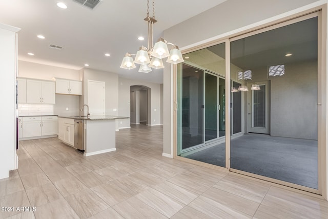 kitchen with a center island with sink, sink, white cabinetry, pendant lighting, and dishwasher