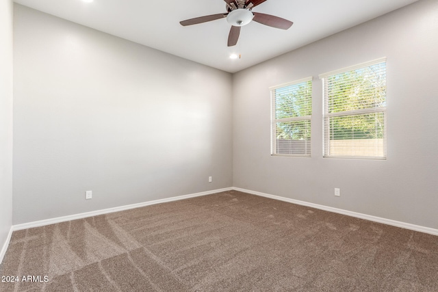 carpeted empty room featuring ceiling fan