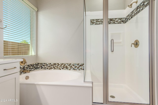 bathroom featuring vanity and separate shower and tub