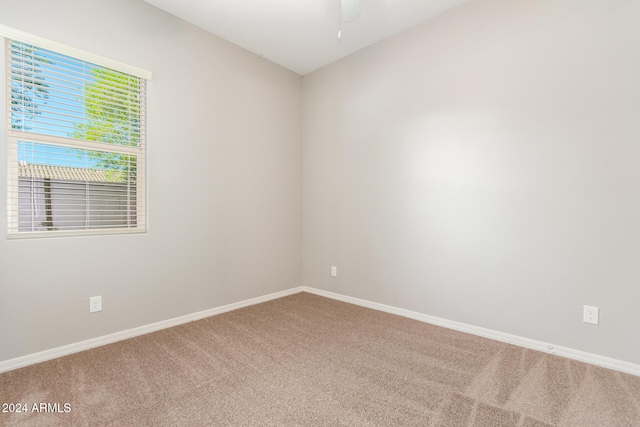 unfurnished room with ceiling fan and carpet floors