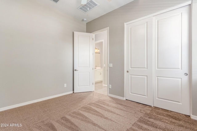 unfurnished bedroom featuring carpet flooring and a closet