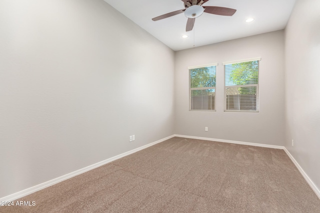 carpeted empty room featuring ceiling fan