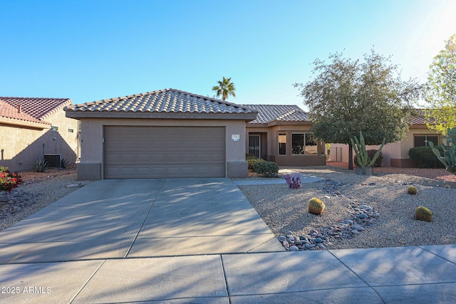 view of front of property with a garage and central AC unit