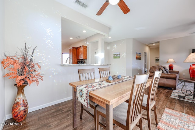 dining room with ceiling fan and dark wood-type flooring