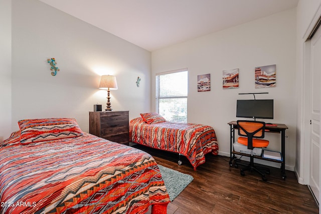 bedroom with dark hardwood / wood-style flooring