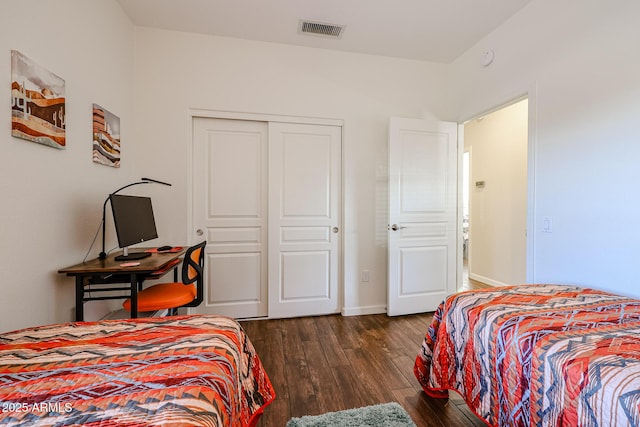 bedroom featuring a closet and dark hardwood / wood-style flooring