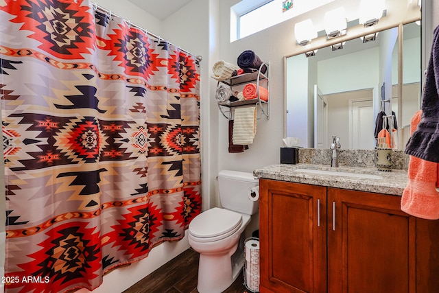 bathroom with hardwood / wood-style flooring, toilet, and vanity