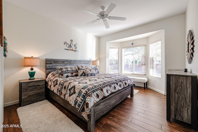 bedroom with ceiling fan and dark hardwood / wood-style flooring