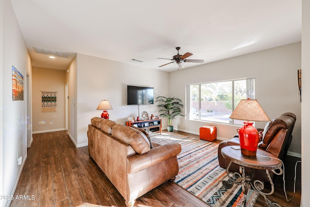 living room with ceiling fan and dark wood-type flooring