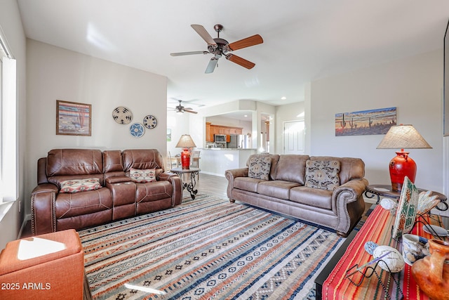 living room featuring hardwood / wood-style floors and ceiling fan