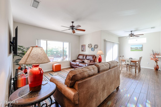 living room with ceiling fan and dark hardwood / wood-style flooring