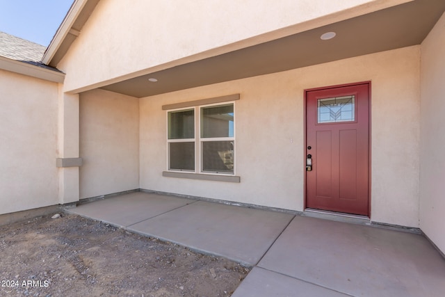 property entrance featuring a patio area