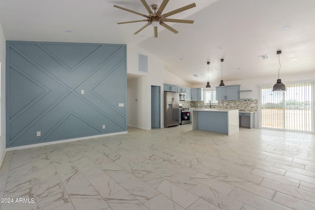 kitchen with lofted ceiling, stainless steel appliances, backsplash, a center island, and pendant lighting