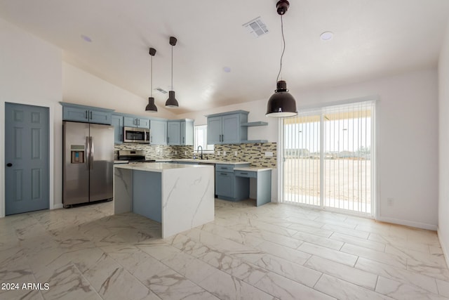 kitchen with pendant lighting, vaulted ceiling, stainless steel appliances, and backsplash