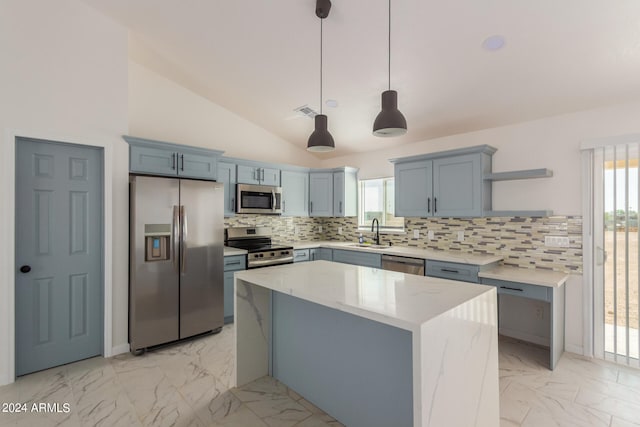 kitchen with a kitchen island, backsplash, hanging light fixtures, stainless steel appliances, and lofted ceiling