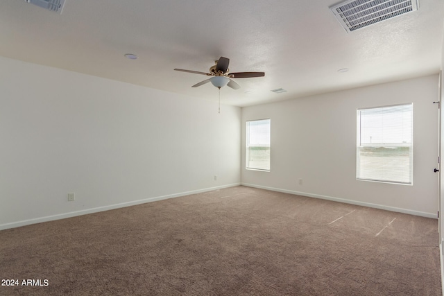 empty room with ceiling fan and carpet