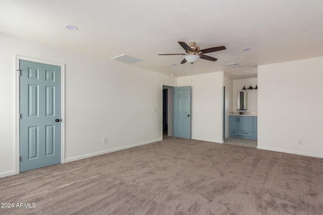 interior space with light carpet and ceiling fan