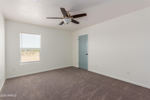 spare room with carpet and ceiling fan