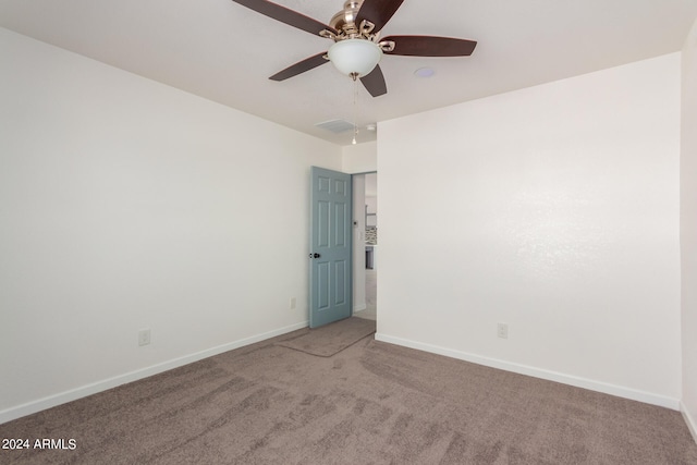 spare room featuring carpet and ceiling fan