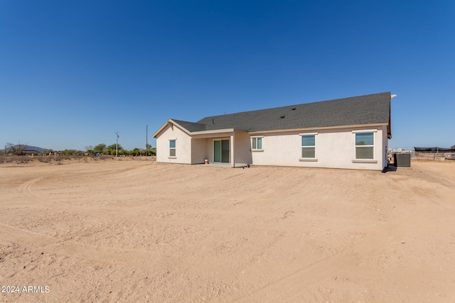 rear view of property featuring central AC unit