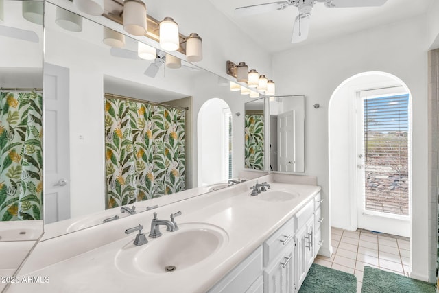 full bathroom featuring tile patterned flooring, double vanity, a ceiling fan, and a sink