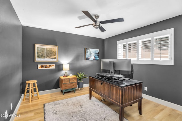 office area featuring baseboards, a ceiling fan, and wood finished floors