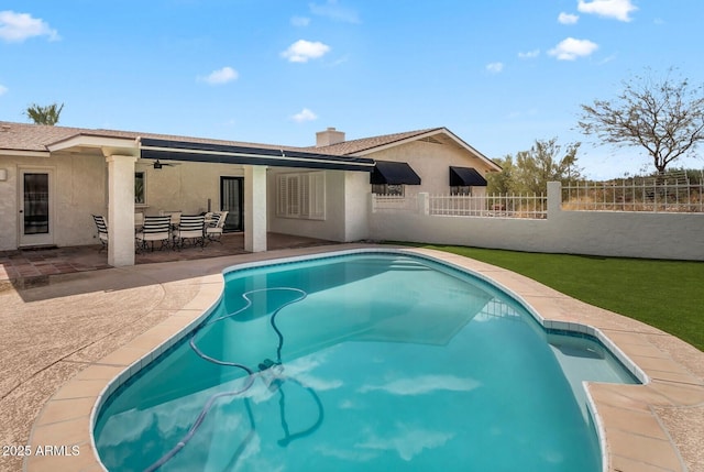 view of swimming pool with a patio area, a fenced in pool, a ceiling fan, and fence