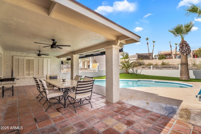 view of pool featuring a fenced in pool, fence, a patio, outdoor dining space, and a ceiling fan