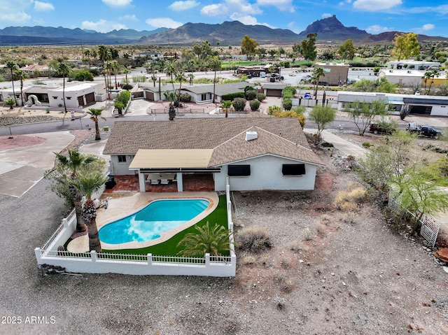 view of swimming pool featuring a mountain view and a fenced backyard