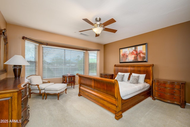 bedroom featuring ceiling fan, visible vents, and light carpet