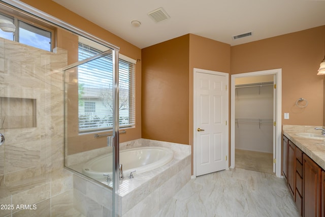 full bathroom with visible vents, vanity, a bath, and a shower stall