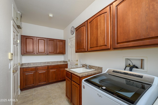 laundry room with a sink, cabinet space, washer / dryer, and light tile patterned floors