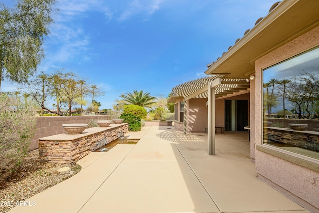 view of patio / terrace featuring a pergola and fence