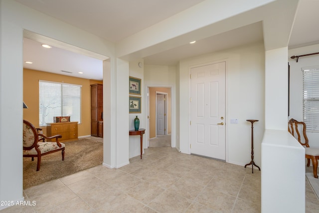 foyer featuring light tile patterned floors, visible vents, recessed lighting, and baseboards