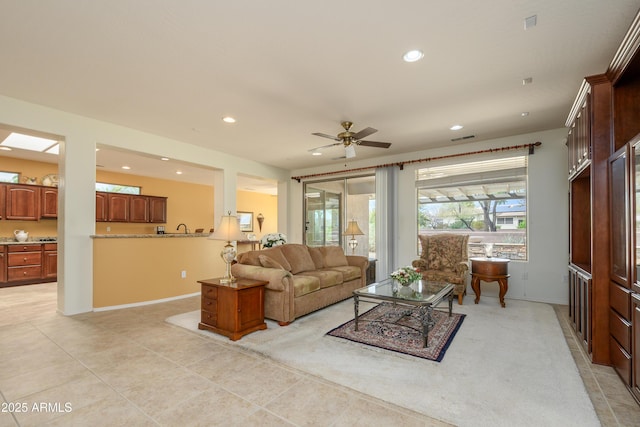 living area with visible vents, baseboards, light tile patterned floors, recessed lighting, and a ceiling fan