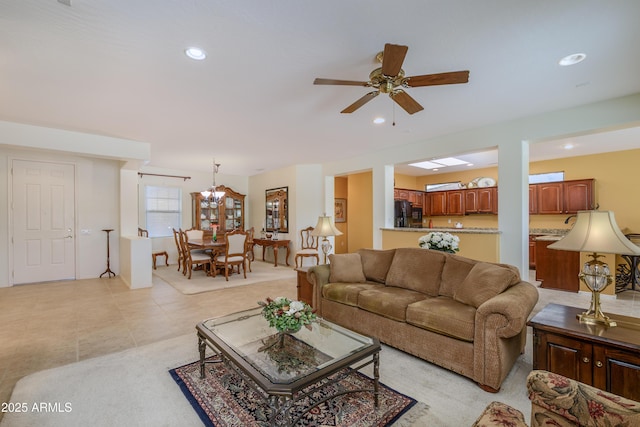 living room featuring recessed lighting, ceiling fan with notable chandelier, and light tile patterned floors