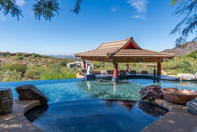 15972 N 115th Way, Scottsdale, AZ 85255 - view of pool with a gazebo, a mountain view, and an infinity pool
