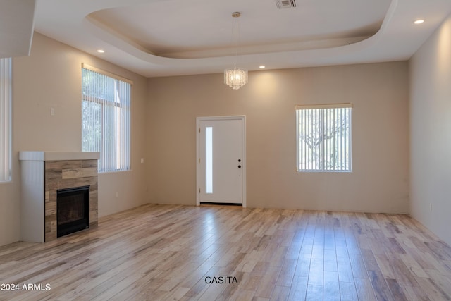 15972 N 115th Way, Scottsdale, AZ 85255 - foyer with a raised ceiling, light wood finished floors, a glass covered fireplace, and recessed lighting