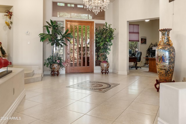 15972 N 115th Way, Scottsdale, AZ 85255 - foyer with light tile patterned floors, a high ceiling, a chandelier, and baseboards