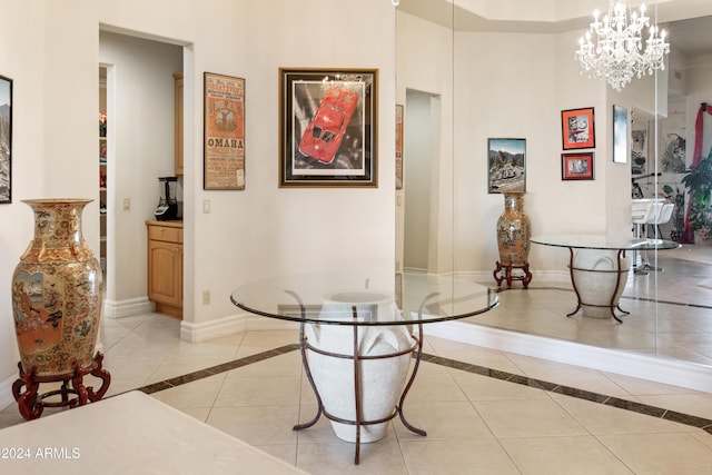 15972 N 115th Way, Scottsdale, AZ 85255 - dining space with inlaid floor details, baseboards, a chandelier, a high ceiling, and light tile patterned floors